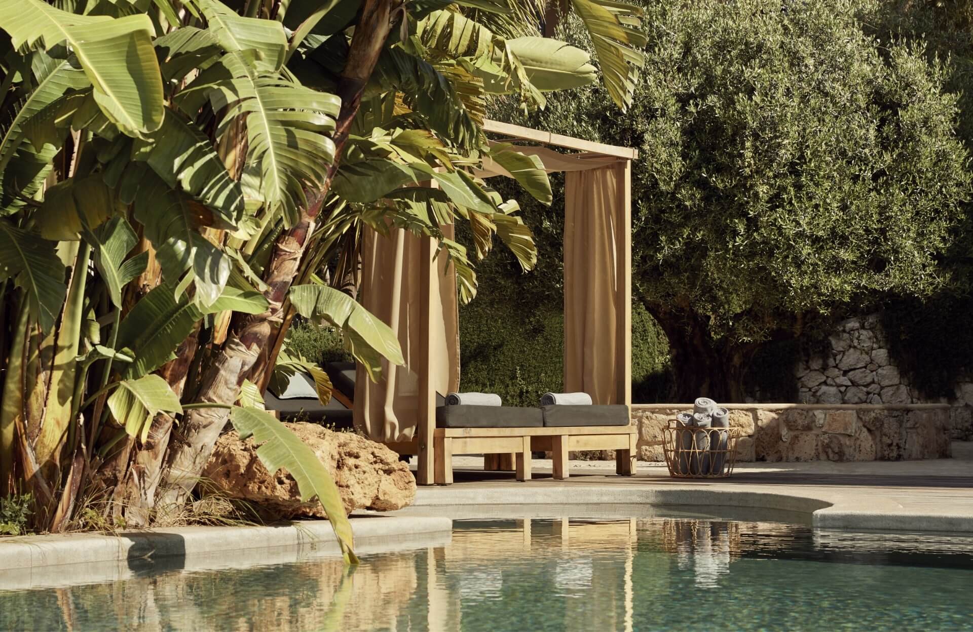 two sunbeds beside a pool on Fzeen Suite