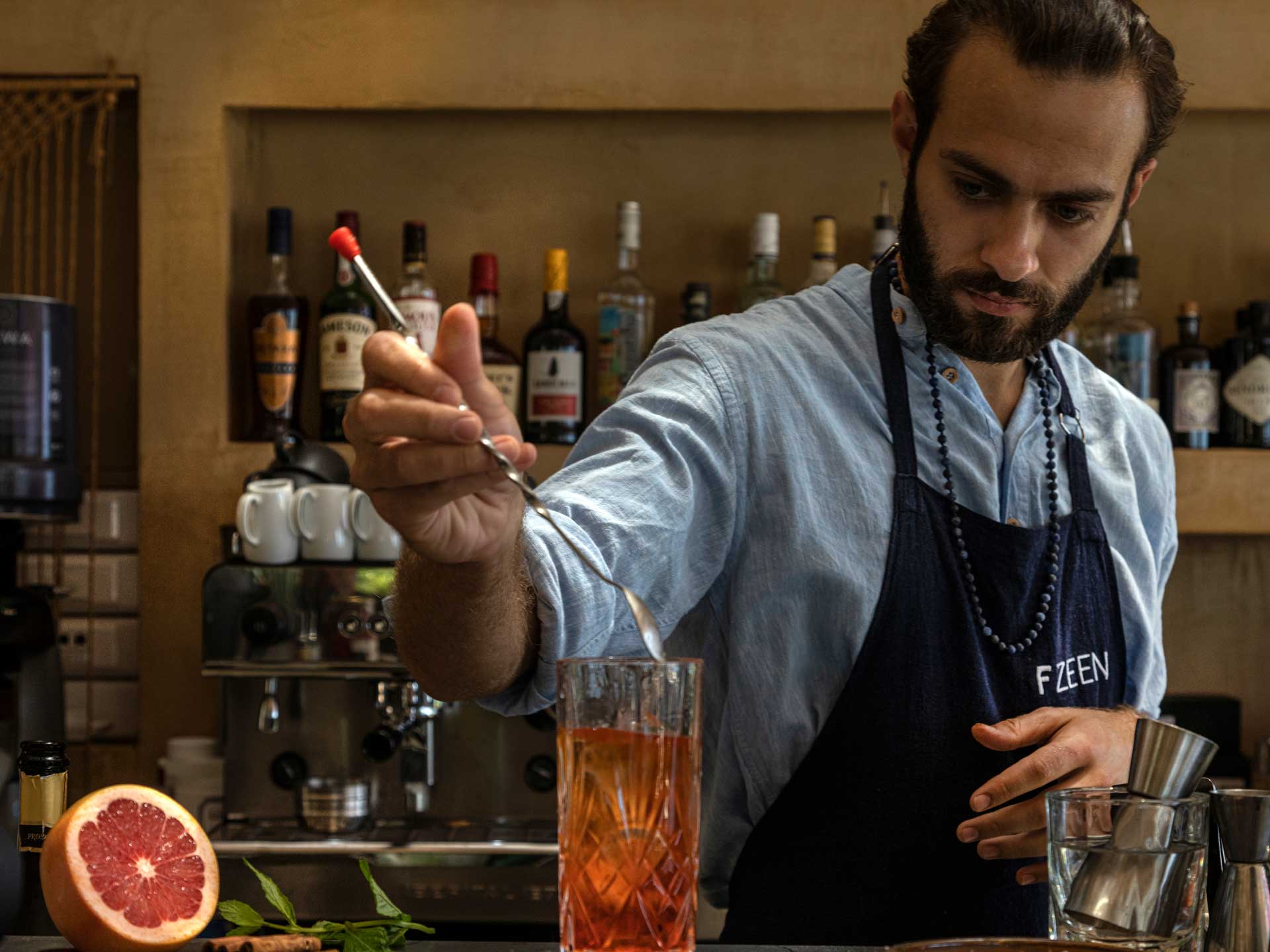 a bartender mixing a cocktail a