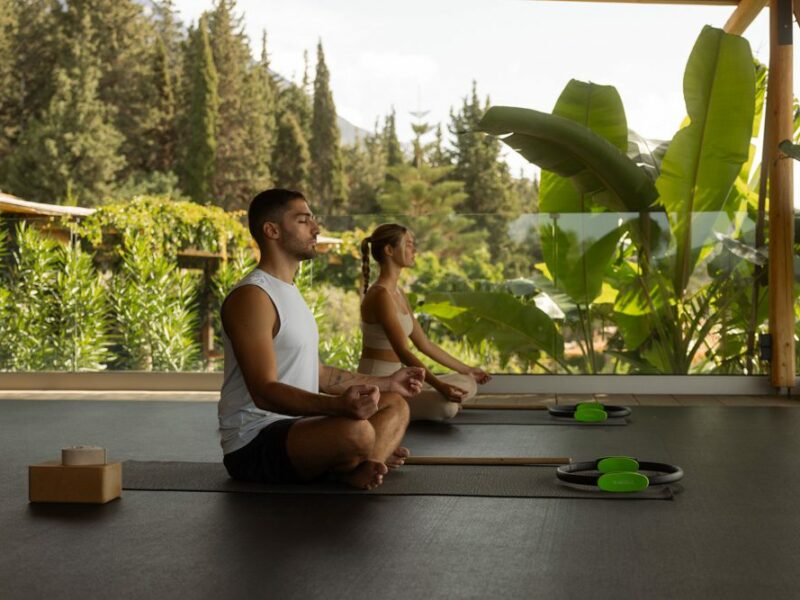 a man and a woman doing yoga